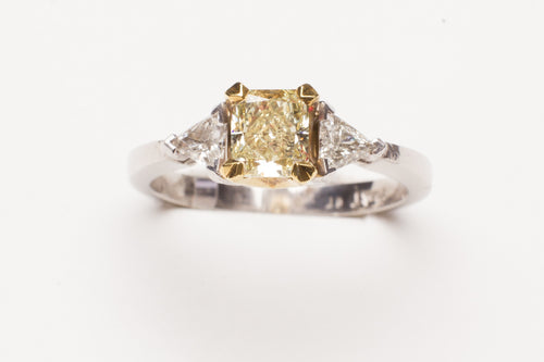 PLAT/18KT .78CT RAD SI1 FANCY YELLOW W .25CTTW TRILL